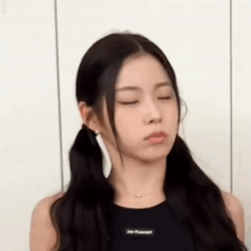 A Woman With Pigtails Is Making A Funny Face . GIF