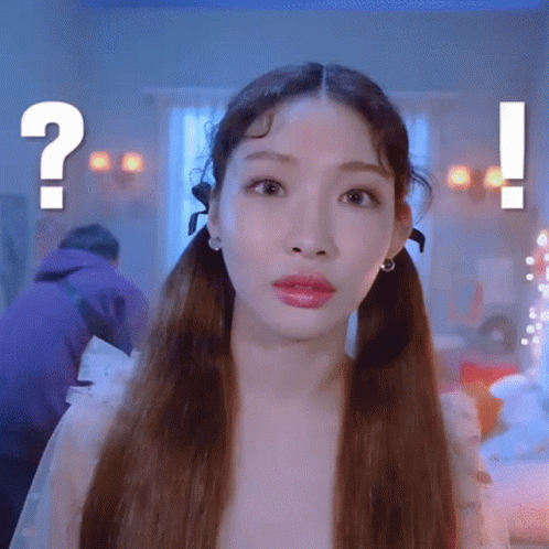 A Woman With Pigtails Is Making A Funny Face With A Question Mark In The Background . GIF
