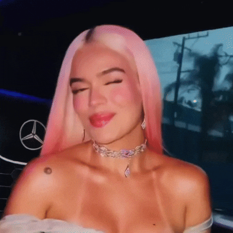 A Woman With Pink Hair And A Choker Is Smiling GIF