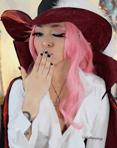 A Woman With Pink Hair And A White Shirt That Says Lordofdumplings On It GIF