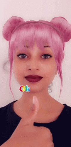 A Woman With Pink Hair Gives A Thumbs Up GIF