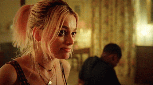 A Woman With Pink Hair Has A Nose Ring On Her Nose GIF