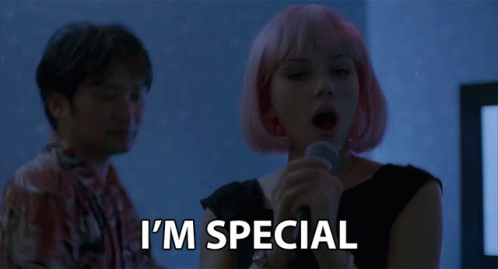A Woman With Pink Hair Is Singing Into A Microphone And The Words I 'M Special Are Below Her GIF