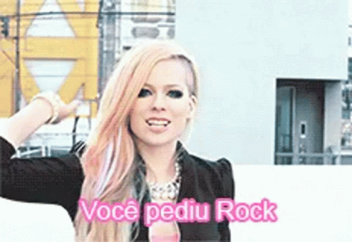 A Woman With Pink Hair Is Standing In Front Of A Building And Says Voce Pediu Rock GIF
