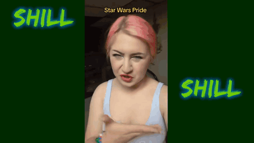 A Woman With Pink Hair Is Standing In Front Of A Sign That Says Shill GIF