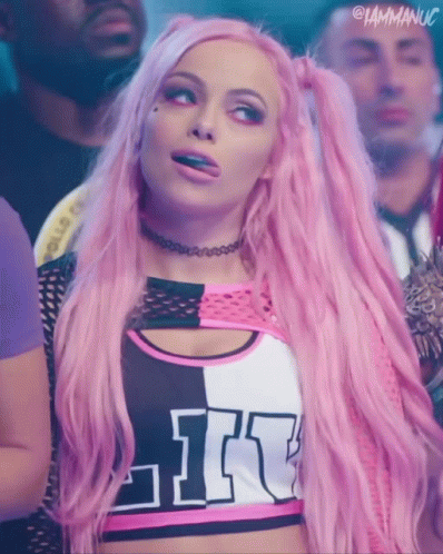 A Woman With Pink Hair Is Wearing A Top That Says Like On It GIF