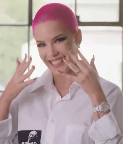 A Woman With Pink Hair Is Wearing A White Shirt With A Picture Of A Woman On It GIF