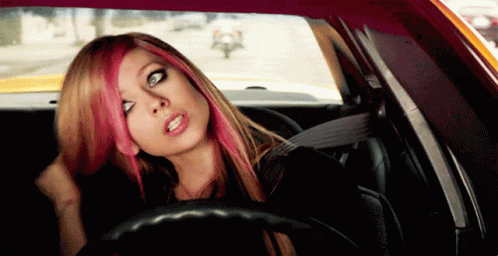 A Woman With Pink Hair Sits In A Car GIF