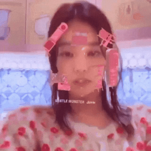 A Woman With Pink Stickers On Her Face Is Taking A Selfie In A Bathtub . GIF