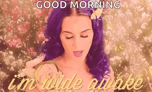 A Woman With Purple Hair And A Flower In Her Hair Is Saying `` Good Morning , I 'M Wide Awake '' . GIF