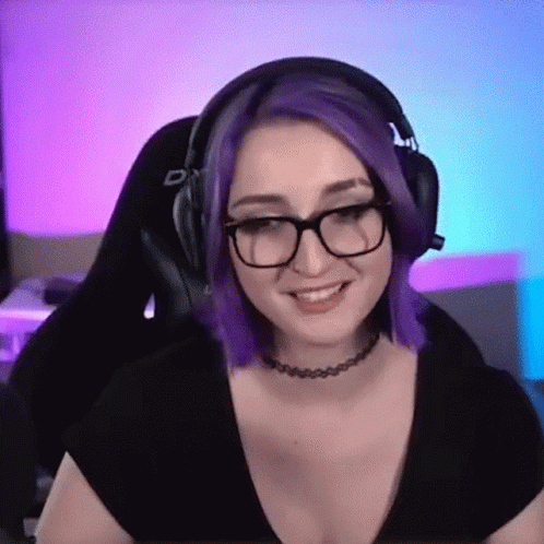 A Woman With Purple Hair And Glasses Is Wearing Headphones GIF