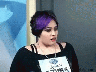 A Woman With Purple Hair Has A Name Tag That Says Arabic Gifs On It GIF