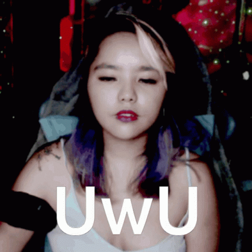 A Woman With Purple Hair Has The Word Uwu Written On Her Chest GIF