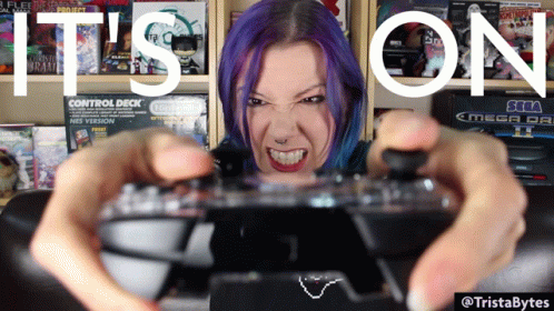 A Woman With Purple Hair Is Holding A Video Game Controller With The Words " It 'S On " Written Above Her GIF