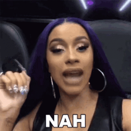 A Woman With Purple Hair Is Sitting In A Chair With Her Mouth Open And Says Nah . GIF