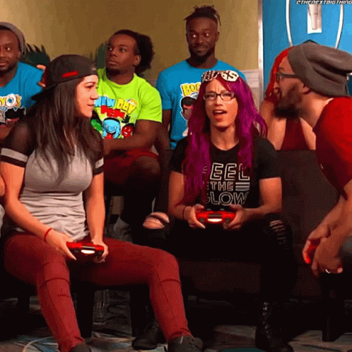 A Woman With Purple Hair Is Wearing A Black Shirt That Says Feel The Low GIF