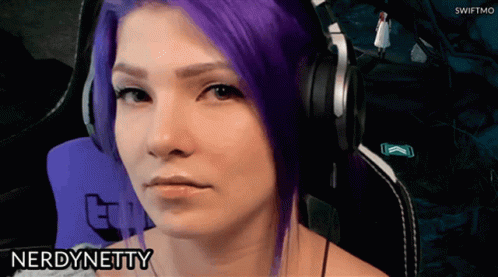 a woman with purple hair is wearing headphones and the name nerd netty is on the bottom right