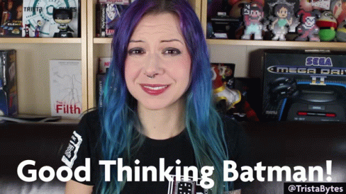 A Woman With Purple Hair Says Good Thinking Batman In Front Of A Sega Mega Drive GIF