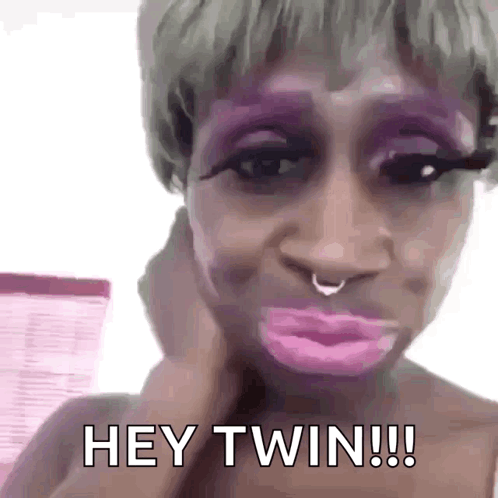 A Woman With Purple Makeup And A Nose Ring Is Making A Funny Face And Saying Hey Twin . GIF
