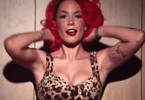 A Woman With Red Hair And A Leopard Print Bra GIF