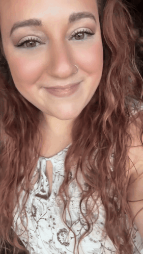 A Woman With Red Hair And A Nose Ring Smiles GIF