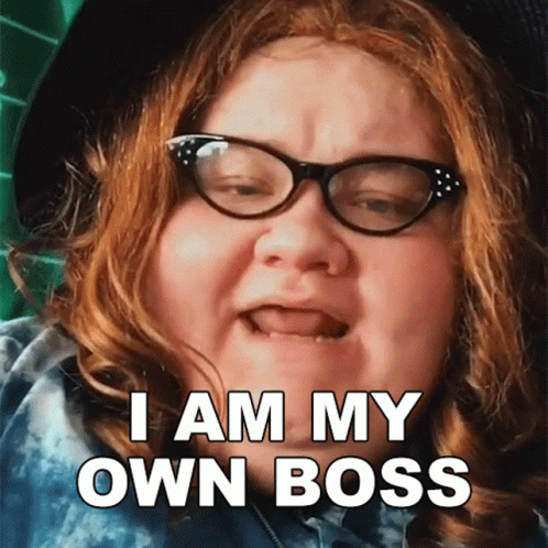 a woman with red hair and glasses says i am my own boss