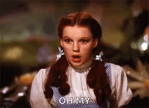 A Woman With Red Hair And Pigtails Is Making A Surprised Face And Saying Oh My . GIF