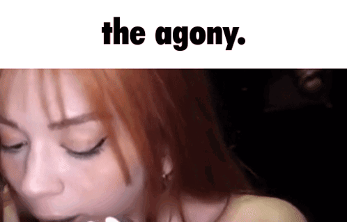 A Woman With Red Hair Has Her Eyes Closed And The Words The Agony Are Above Her GIF