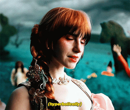 A Woman With Red Hair Has The Word Hyperbolically Written Above Her GIF