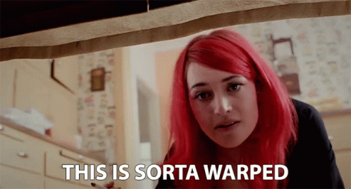 A Woman With Red Hair Has The Words This Is Sorta Warped Above Her GIF
