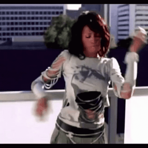Woman With Red Hair Dancing On Balcony GIF
