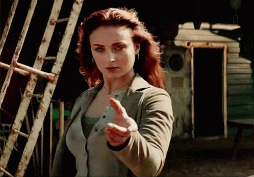 A Woman With Red Hair Is Giving A Thumbs Up GIF