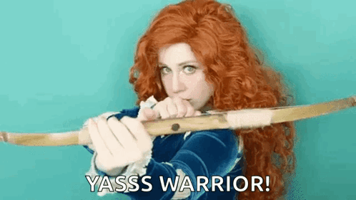 A Woman With Red Hair Is Holding A Bow And Arrow And Says Yasss Warrior ! GIF
