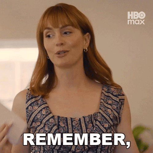 A Woman With Red Hair Is Holding A Piece Of Paper And Says " Remember " GIF