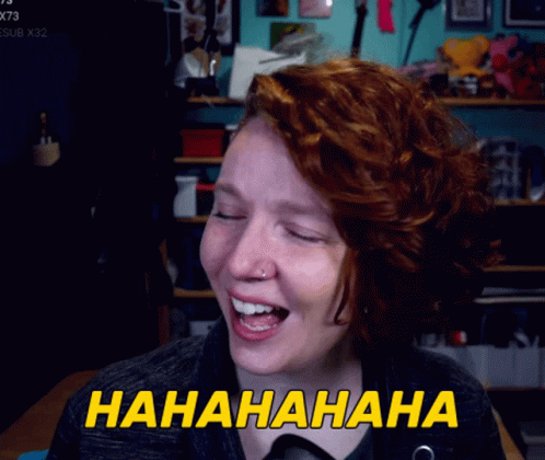 A Woman With Red Hair Is Laughing With The Words Hahahaha Written In Yellow GIF