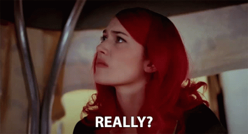 A Woman With Red Hair Is Looking Up And Says Really ? GIF