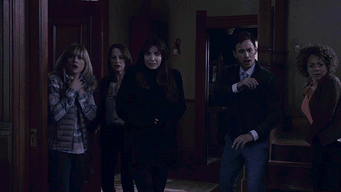 A Woman With Red Hair Is Screaming While Another Woman Stands Behind Her GIF