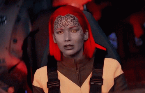 A Woman With Red Hair Is Sitting In A Car GIF