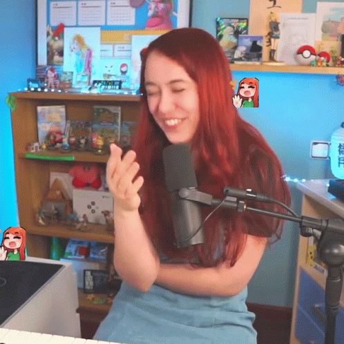 A Woman With Red Hair Is Sitting In Front Of A Microphone And Smiling GIF