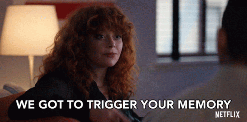 A Woman With Red Hair Is Sitting Next To A Man And Says We Got To Trigger Your Memory GIF