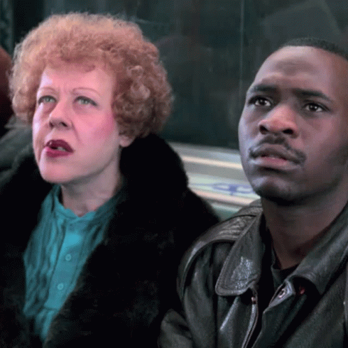 Woman With Red Hair Sitting Next To Man In Leather Jacket GIF