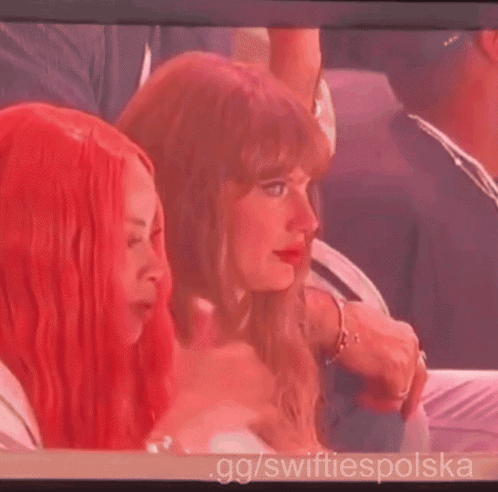 A Woman With Red Hair Is Sitting Next To Another Woman On A Screen With Gg / Swiftiespolska Written On It GIF