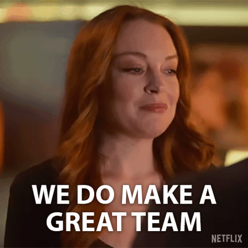 A Woman With Red Hair Is Smiling And Saying We Do Make A Great Team . GIF