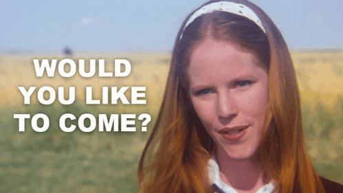 A Woman With Red Hair Is Standing In A Field With The Words " Would You Like To Come " Written Above Her GIF