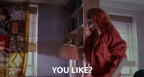 A Woman With Red Hair Is Standing In A Room With The Words " You Like " On The Bottom GIF