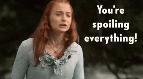 A Woman With Red Hair Is Standing In Front Of A Sign That Says " You 'Re Spoiling Everything " GIF