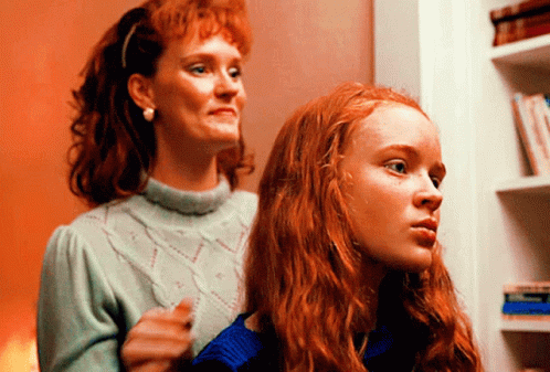A Woman With Red Hair Is Standing Next To A Girl With Red Hair GIF