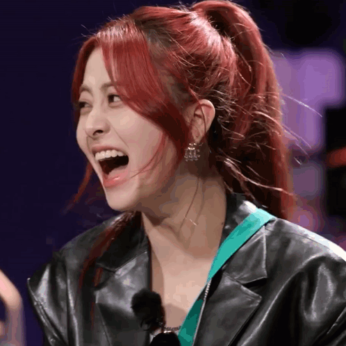 A Woman With Red Hair Is Wearing A Black Jacket GIF