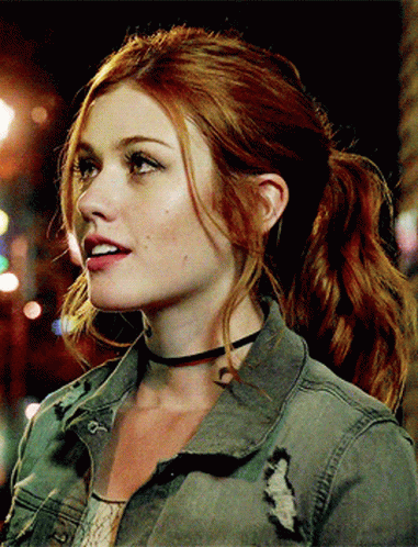 A Woman With Red Hair Is Wearing A Choker And A Ponytail GIF