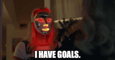 A Woman With Red Hair Is Wearing A Mask And Says I Have Goals GIF